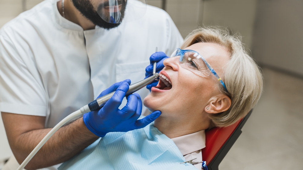 Dentist performing a precise and comfortable dental procedure using modern instruments and patient protection - Dentist in Nashville
