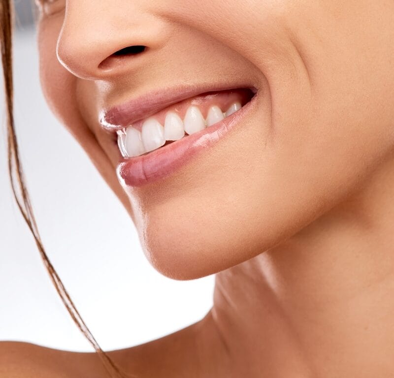 Smile, woman and dental with mouth in studio for hygiene, teeth whitening and orthodontic results. Person, happiness or veneers with oral care, fresh breath and cosmetic treatment on white background