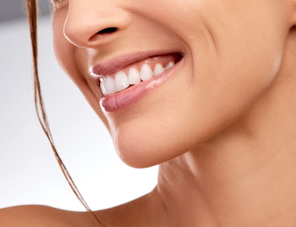 Smile, woman and dental with mouth in studio for hygiene, teeth whitening and orthodontic results. Person, happiness or veneers with oral care, fresh breath and cosmetic treatment on white background