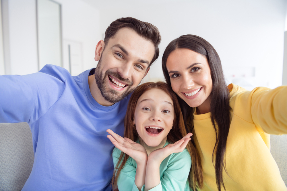 Smiling parents and child enjoying healthy, confident smiles that reflect family-focused dental care - Dentist in Nashville