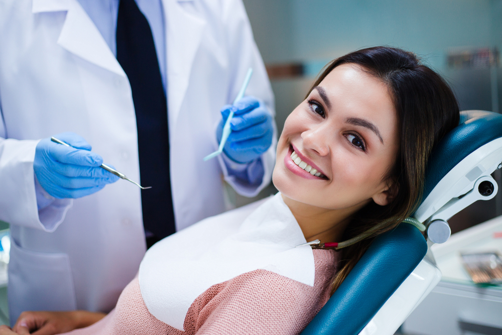 Smiling patient relaxing in the dental chair during a positive and stress-free dental appointment - Dentist in Nashville