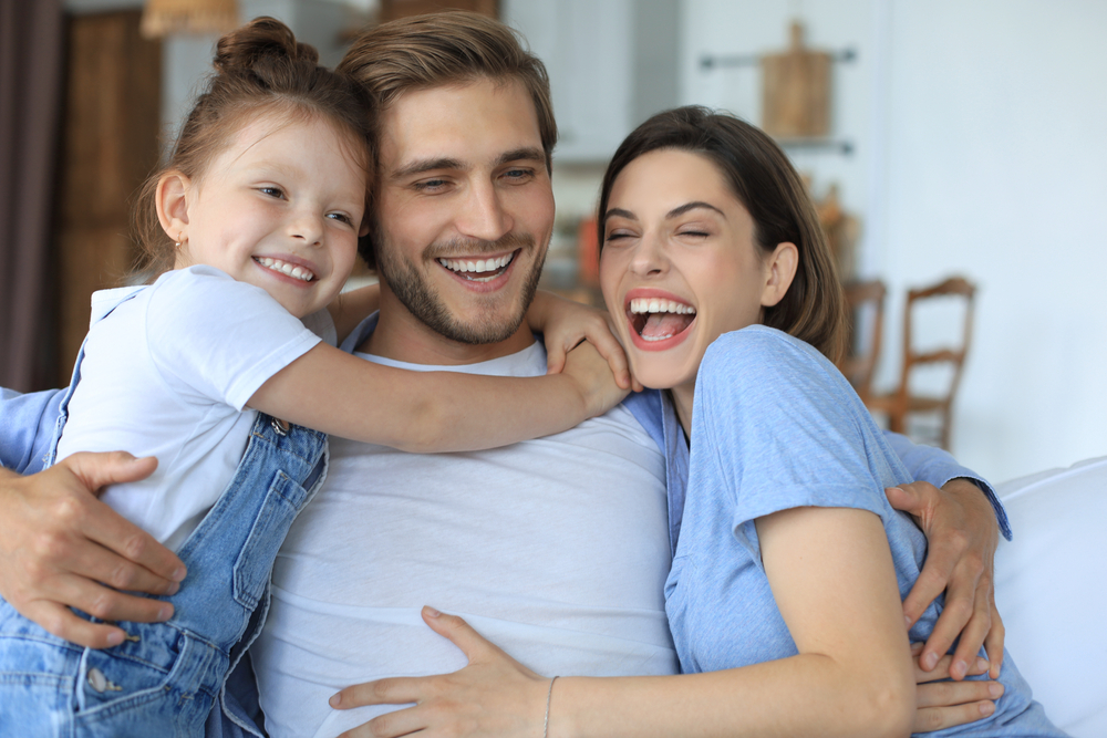 Family smiling together at home, reflecting confidence and happiness after receiving quality family dental services - Berry Hill Dentist